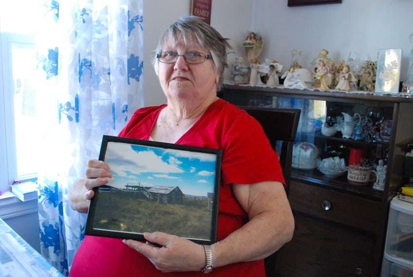 Lucy Mouland with a photo of Walter Mouland’s—her father’s—stage in Mockbeggar, Bonavista.
JONATHAN PARSONS PHOTO