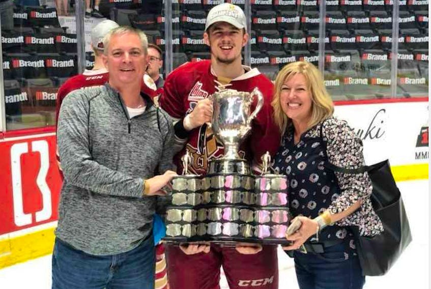 Sydney’s Mitchell Balmas, centre, poses with his parents, Brad and Melanie Balmas, after winning the 2018 MasterCard Memorial Cup in Regina. Balmas, who assisted on the tournament-winning goal, now plays university hockey for the Saint Mary’s Huskies in Halifax. However, the talented goal scorer’s QMJHL legacy continues as a December 2017 trade involving Balmas has set up an interesting scenario at the league’s upcoming entry draft. CONTRIBUTED