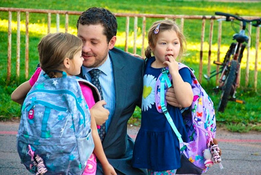 In this file photo, Brandon Forbes drops his daughters off at school in Charlottetown the day after a bomb threat led to the evacuation of all schools in P.E.I.