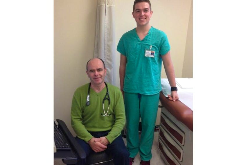 Brent Raddall stands next to Dr. Tim Woodford.  Raddall did a co-op with Queens General Hospital to see what it would be like to be a doctor.