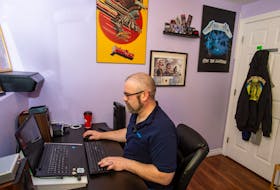 With his heavy metal poster on the wall next to him, Kyle Davis, communications coordinator with Admiral Insurance, works from his home office in Eastern Passage on Friday, Jan. 8.
Ryan Taplin - The Chronicle Herald