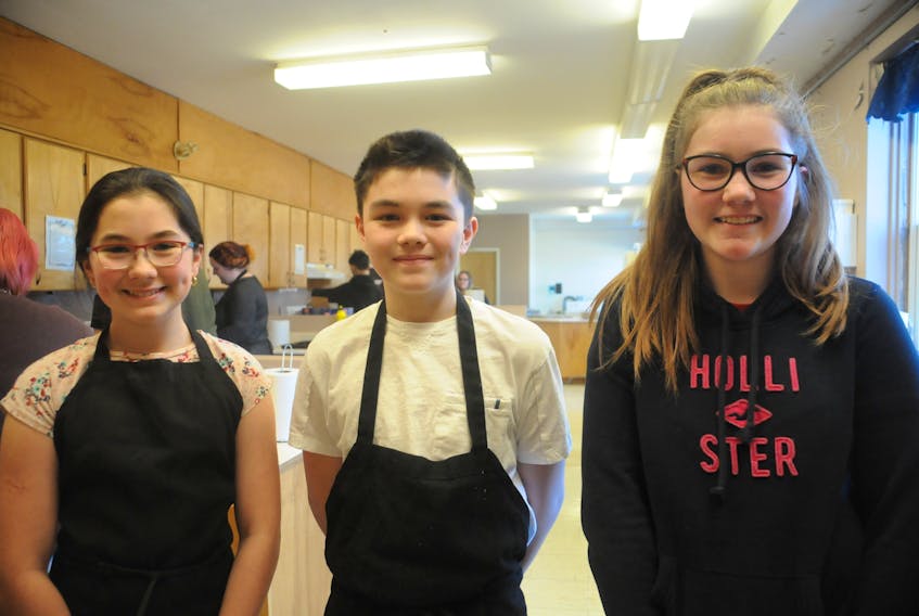 Grade 7 Brother Rice Junior High students (from left) Sofia Alberto, Landen Lee and Brooklyn Fahey are happy to help fellow youth by preparing meals for Thrive in St. John's. ANDREW ROBINSON/THE TELEGRAM