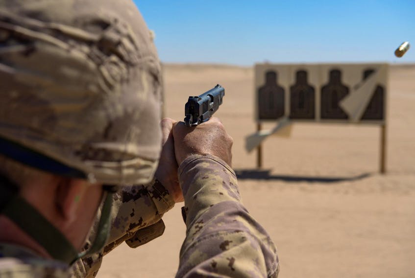 A Canadian Forces member fires his Browning 9mm pistol at a range in Afghanistan. (DND photo)