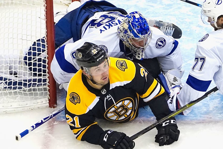 Tampa Bay Lightning goaltender Andrei Vasilevskiy lands on top of Nick Ritchie of the Boston Bruins during Eastern Conference round robin play on Wednesday.
