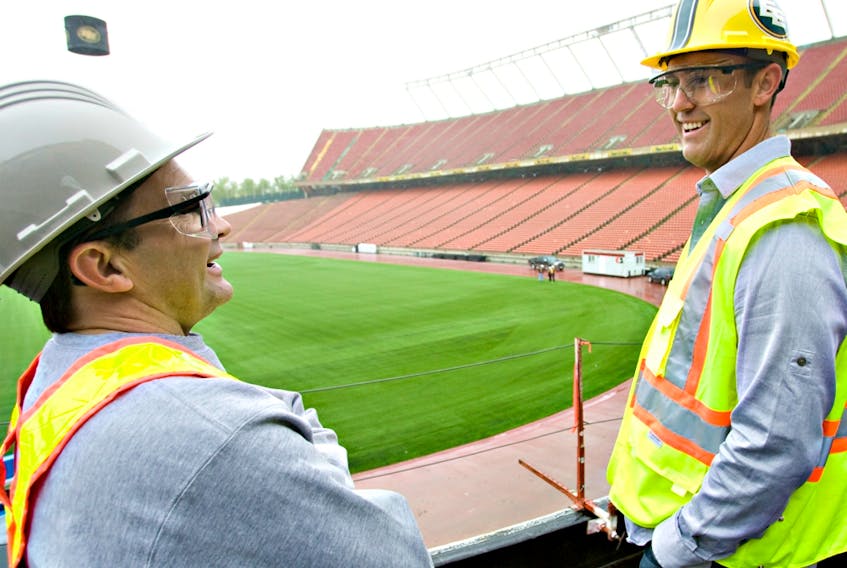 Edmonton quarterback Ricky Ray checks out a tour of the new facilities under construction at Commonwealth Stadium alongside team equipment manager Dwayne Mandrusiak in this file photo taken May 21, 2010.