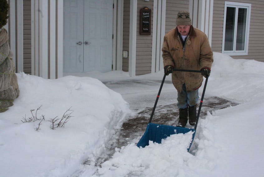 Tim Brake shovels wet and heavy snow from the walkway of the Jehovah’s Witness Kingdom Hall in Marystown Monday afternoon, Jan. 20, deposited from the night before. PAUL HERRIDGE/THE SOUTHERN GAZETTE