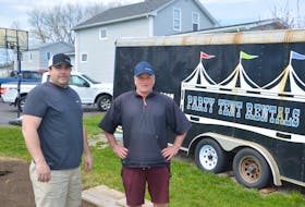 C & I Party Tent Rental owners Ian Burke, left, and Charlie Oliver stand near their business trailer last week. The New Waterford-based business has had most of its summer bookings cancelled because of COVID-19. JEREMY FRASER/CAPE BRETON POST