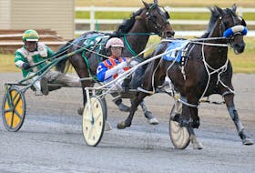 Major Custard and driver J. Brandon Campbell leads Speaking of Art and driver Keith L. Clark down the final stretch to win the Ralph Klein Memorial race at Century Downs Race Track in Calgary on Aug. 29, 2020.