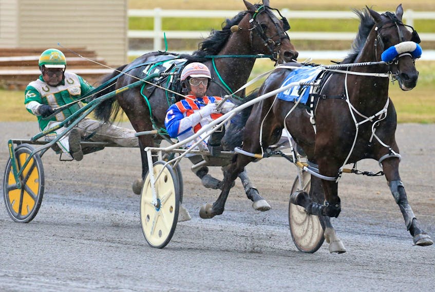 Major Custard and driver J. Brandon Campbell leads Speaking of Art and driver Keith L. Clark down the final stretch to win the Ralph Klein Memorial race at Century Downs Race Track in Calgary on Aug. 29, 2020.