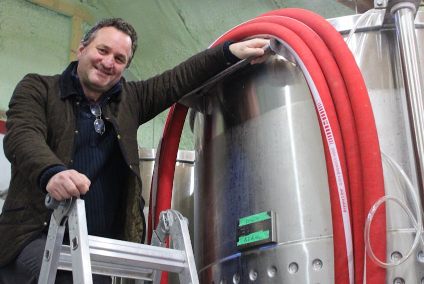 Sebastian Manago, owner of Double Hill Cider, stands near one of his cidery's tanks in Caledonia on April 14.