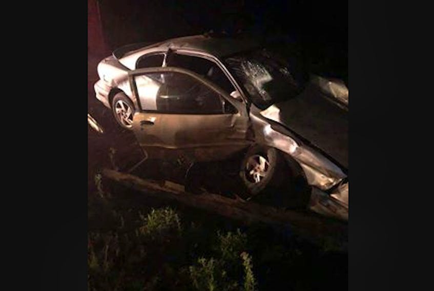 An 18-year-old man is facing numerous charges in relation to the moments leading up to this Pontaic Sunfire striking another vehicle and a utility pole on Cambridge Road around 10:30 p.m. Aug. 4. (Graig Brenton photo)