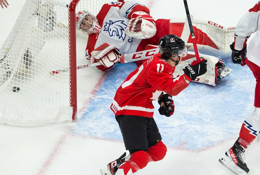 Canada's Cole Perfetti (11) celebrates a goal scored on Czech Republic's goalie Nick Malik (30) in their IIHF world junior championship quarter-final on Saturday, Jan. 2, 2021 in Edmonton.