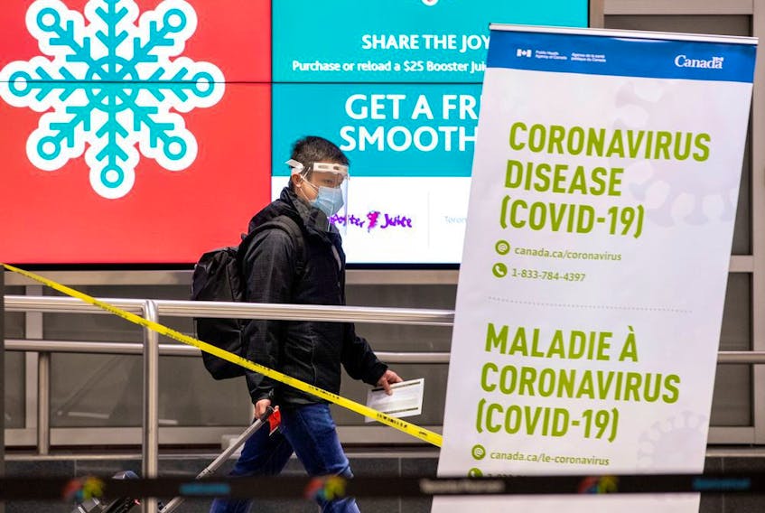 FILE PHOTO: A man walks through terminal 3, amid a spike in coronavirus disease (COVID-19) cases, at Pearson airport near Toronto, Ontario, Canada December 30, 2020.  