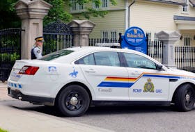 A police officer guards the front gate to Rideau Hall, and the grounds where Prime Minister Justin Trudeau lives, after an armed man was apprehended on the property, on July 2.