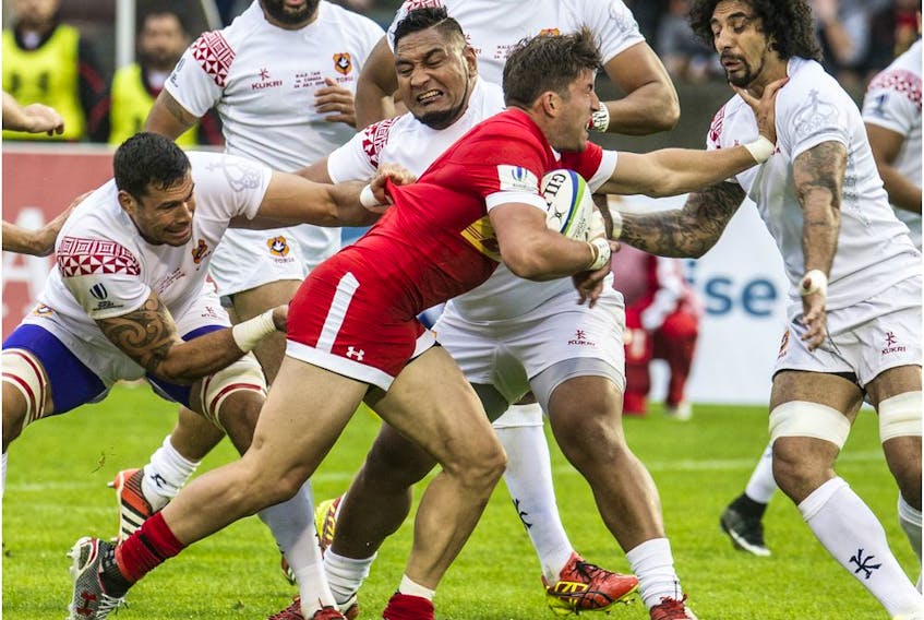 Canada's DTH van der Merwe battles past a trio of Tongans in Pacific Nations Cup rugby action at Swangard Stadium in Vancouver, B.C. on July 24, 2015.