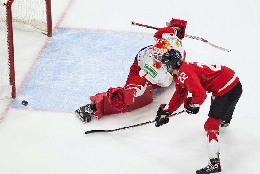 Canada's Dylan Cozens (22) misses a penalty shot on Russia's Yaroslav Askarov (1) during second period IIHF World Junior Hockey Championship semifinal action on Monday, Jan. 4, 2021 in Edmonton. 