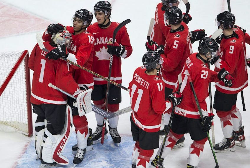 Canada celebrates after defeating Russia 5-0 in IHF World Junior Hockey Championship semifinal action on Monday, Jan. 4, 2021 in Edmonton. 