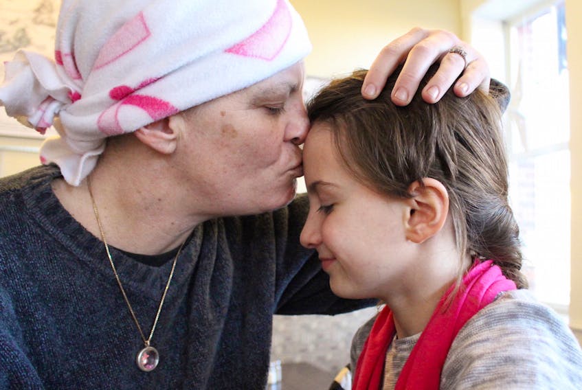 Misty-Lynn Caseley gives her daughter, Charisma a peck on the forehead. Caseley was diagnosed with breast cancer earlier this year. Recently a benefit held in Caseley’s name has provided financial security for the Christmas season.  MILLICENT MCKAY/JOURNAL PIONEER