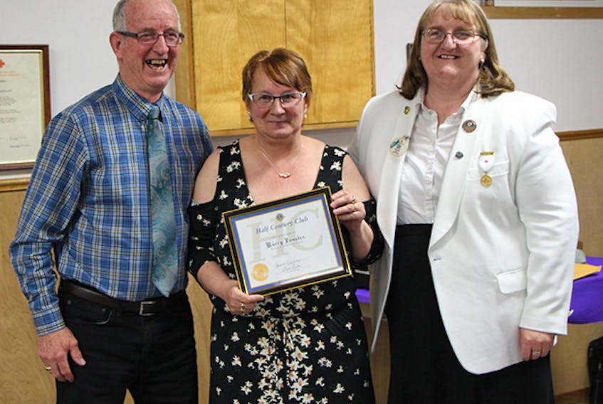 Charter Member Lion Barry Lumsden (left) receives his Lions International 50-year pin and certificate from King Lion Janet Delorey and District Governor Rhonda Trickett during the Canso Lions Club’s 50th anniversary charter night during a May 26 celebration. Submitted