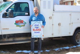 Lorne Currie, owner of Sign Source, holds one of the Stay the Blazes Home signs he originally designed for his mother who wanted something in her window showing her support for Nova Scotia order to stay home during the COVID-19 outbreak. Now the Westmount man is selling them for $25 (taxes included) and donating a portion of sales to Feed Nova Scotia to help them meet demand during the pandemic, which has caused mass layoffs across the province and country. Orders are taken by phone at 902-565-9655 or through the company website signsourcesigns.com/blazes . People can pick-up the signs or have them delivered to most areas of the Cape Breton Regional Municipality. Taxi delivery can also be arranged. Stay the Blazes Home has been a popular phrase across Nova Scotia since Premier Stephen McNeil said it during a daily briefing on COVID-19 developments in the province last month. NICOLE SULLIVAN/CAPE BRETON POST 