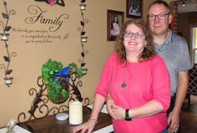 Carrie Ann Maloney and her husband of 23 years, Troy, stand in the living room of their Howie Centre home on Oct. 7 - two and a half years since Carrie Ann was diagnosed with stage 4 melanoma cancer. NICOLE SULLIVAN/CAPE BRETON POST 