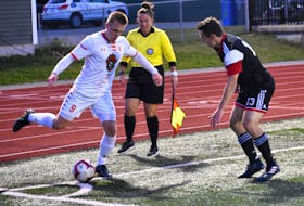 In this file photo, Charlie Waters of the Cape Breton Capers, left, attempts to work his way around Nick Ellingwood of the New Brunswick Reds during Atlantic University Sport men’s soccer action at the Cape Breton Health Recreation Complex. In June, the AUS cancelled the fall sports season due to the COVID-19 pandemic. JEREMY FRASER/CAPE BRETON POST