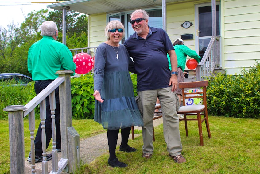 Judy and Wilfred Butler stand at their Sydney home as the Cape Breton Chordsmen set up to serenade the couple to celebrate their 50th wedding anniversary last Saturday. NICOLE SULLIVAN • CAPE BRETON POST 