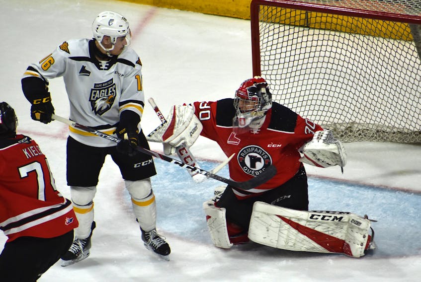In this file photo, Shawn Element of the Cape Breton Eagles, left, attempts to redirect a shot on Quebec Remparts netminder Emerik Despatie during Quebec Major Junior Hockey League action at Centre 200 in March. The Eagles will host the Saint John Sea Dogs Friday at 7 p.m. at Centre 200 in Sydney.JEREMY FRASER/CAPE BRETON POST
