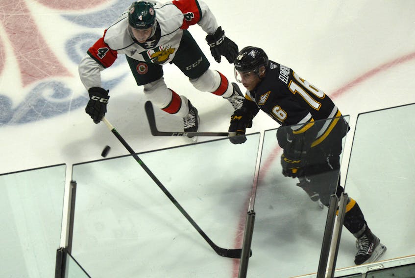 Shawn Element of the Cape Breton Eagles, right, looks at a bouncing puck as he battles with Jake Furlong of the Halifax Mooseheads during Quebec Major Junior Hockey League action at Centre 200 last month. Cape Breton will host the Saint John Sea Dogs on Wednesday at 7 p.m. at Centre 200 in Sydney. JEREMY FRASER • CAPE BRETON POST