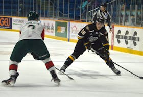 Forward Shawn Element, right, works his way around Brendan Tomilson of the Halifax Mooseheads during a Quebec Major Junior Hockey League game earlier this season at Centre 200 in Sydney. Element was recently traded to his hometown Victoriaville Tigres. JEREMY FRASER/CAPE BRETON POST