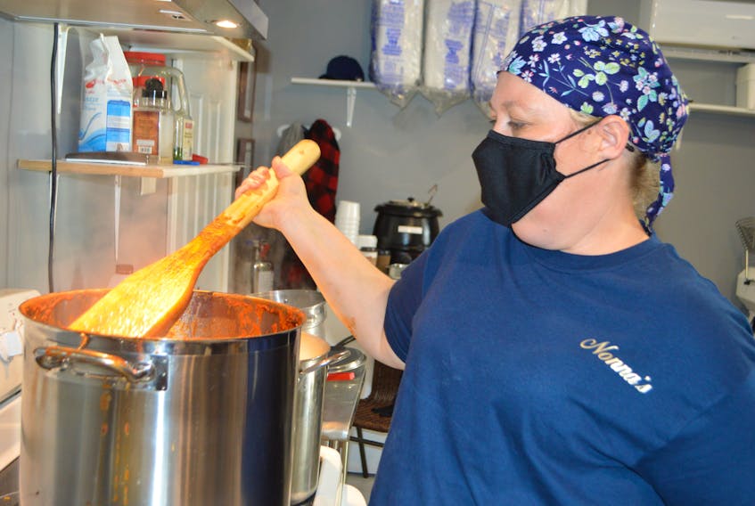 Renee MacKenzie of New Waterford stirs a pot of spaghetti sauce at her new takeout restaurant, Nonna’s Italiano, on Plummer Avenue. MacKenzie, an emergency room nurse at the Glace Bay Hospital, said she had a 20-year dream of opening the restaurant and finally found the courage to do it. Sharon Montgomery-Dupe • Cape Breton Post