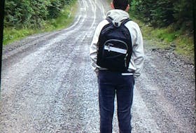 Aidan Matheson, 13, looks down the gravel road he lives on, which he walks to get to the bus stop. His family is concerned the 2.4 km walk, often in the dark during late fall and winter, isn't safe. CONTRIBUTED   
