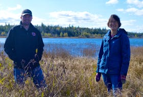 Jeff McNeil, president of the Port Morien Wildlife Association, stands with former co-landowner Catherine Fergusson on the lakeside property her family recently donated to Ducks Unlimited and that will be managed by the wildlife group. DAVID JALA • CAPE BRETON POST