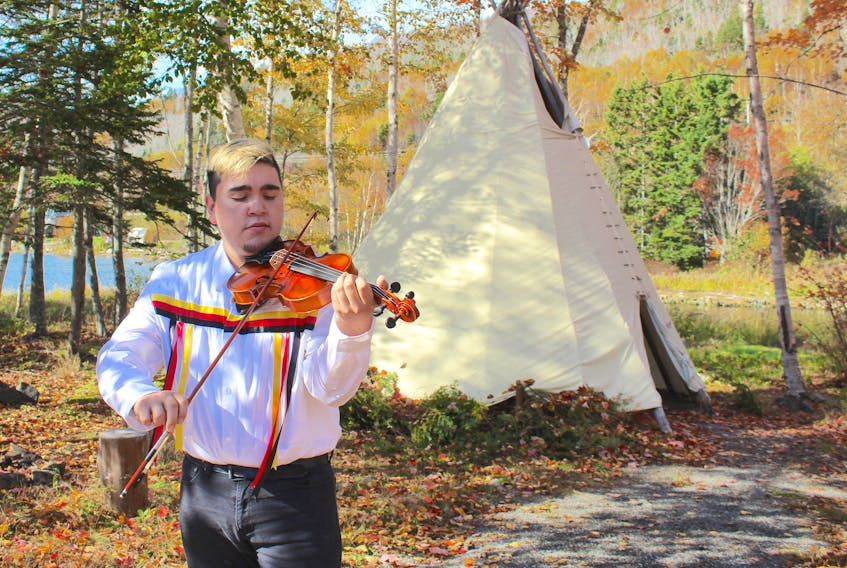 Morgan Toney, a Mi’kmaq fiddling sensation originally from We’koma’q and Wagmatcook First Nations, plays at Goat Island in Eskasoni before shooting a music video for his new song. Chris Connors/Cape Breton Post