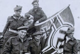 Maj. Harry Boates, CMS John MacQueen, Capt. Fox, Lieut. Casey and Lieut. Reg Roy of the Cape Breton Highlanders are shown with a captured German battle flag. CONTRIBUTED