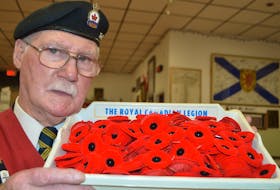 Doe McGrath, sergeant-at-arms for Branch 3 of the Royal Canadian Legion in Glace Bay, holds a tray of poppies. McGrath said they do have a member or veteran in some stores for the poppy campaign but all stores aren’t allowing them inside this year due to the pandemic and their legion doesn’t want their members standing out in the cold. Sharon Montgomery-Dupe/Cape Breton Post
