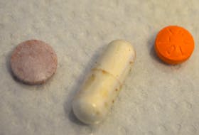 The pills a Glace Bay man says his family found in a bag of Planters Craft Bar Mix on Sunday. The orange pill has letters embedded on it, the capsule and purple pill don’t appear to have any markings. Sharon Montgomery-Dupe/Cape Breton Post