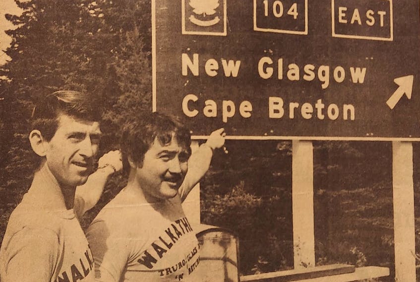 John McIntyre, left, and Harold Perro point to highway sign as they set on a walk from Truro to Glace Bay, and back, in 1979. McIntyre, whose father was paralyzed in a mining accident, was raising money for the Canadian Paraplegic Association while Perro’s share went to the Nova Scotia Heart Foundation in the name of his father, who had died of a heart attack. Contributed