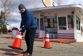 Fred Squarey, owner of Frosty's in Coxheath, puts pylons in place in front of the restaurant that encourage customers to practise safe isolation distances. GREG MCNEIL/CAPE BRETON POST
