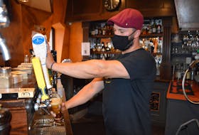 Tyler MacIntyre pours a cold one at Governor's Pub and Eatery in downtown Sydney. GREG MCNEIL/CAPE BRETON POST