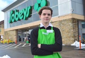 Max MacGillivary, 18, of Dominion, a cashier at Sobeys in Glace Bay, stands in front of the store on Reserve Street. MacGillivary is catching a lot of attention on social media after being witnessed pulling out his wallet after ringing in the groceries for a young family who ended up short money on their grocery order. Sharon Montgomery-Dupe/Cape Breton Post