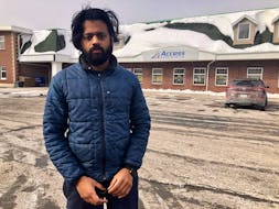 Arjun Shaju, 29, stands outside Access Nova Scotia after reporting his car stolen and blocking the ability for someone to change the ownership from his name to theirs. The Cape Breton University graduate from Kerala, India, had to do this after attempting to sell his car to a man in Sydney, who e-transferred Shaju $5,500 for the purchase from an account he had deposited the cheque Shaju first refused as payment for the car. NICOLE SULLIVAN/CAPE BRETON POST 