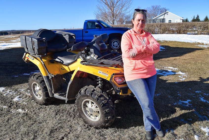 Amy Gerrow of Millville stands by her family’s all-terrain vehicle that her brother Jeff Harrietha was driving on Sept. 5, 2020 when the bike flipped over on a trail on the Alder Point Road, trapping him underneath. Gerrow said although her brother called 911, Cape Breton Regional Police treated the call as a hoax and never searched properly. Her brother died of exposure and hypothermia. Sharon Montgomery-Dupe • Cape Breton Post