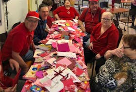 Breton Ability Centre residents open their Valentine’s Day cards last year. Contributed