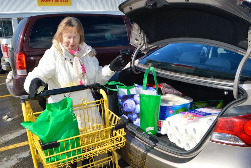 Beverley Burton of Sydney packs groceries from Colbourne's No Frills on Welton Street in Sydney into her car Wednesday. Burton said she is finding some food items hard to get as people appear to be stocking up on supplies due to the coronavirus outbreak. Sharon Montgomery-Dupe/Cape Breton Post