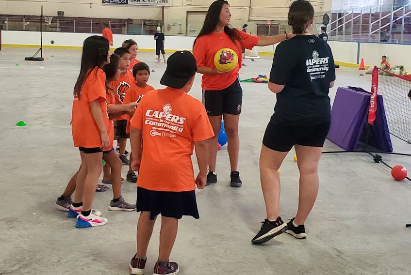 A group of youth gets direction at one of the stations set up at the Dan K. Stevens Memorial Arena for the Capers in the Community program on Thursday. CONTRIBUTED/JEANNINE FAYE DENNY