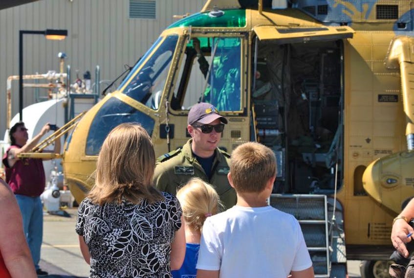 <p>Crew commander Capt. Brenden MacDonald answers questions about the Sea King helicopter he was flying that landed in Trenton this week.&nbsp;</p>