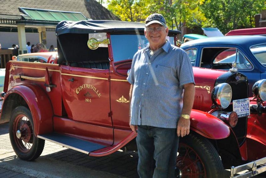 <p>Derek Wood of Centreville proudly displays the 1930 Model A Ford fire truck he restored.</p>