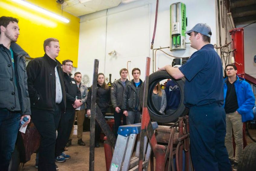 <span class="COLOURKicker">Daniel DesRoches, a red seal automotive technician at OK Tire Auto Service, shows a number of UPEI students the consesquences of driving a long distance on a flat tire, during a course at the shop last week. The two-hour course provided about 20 students with a basic knowledge of caring for their car.</span>