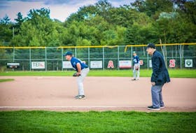 Veteran senior baseball umpire Carl Lake works the first base line at his last baseball game Tuesday night in St. John's.  – Submitted photo by Morgan MacDonald